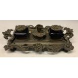 A 19th century bronze inkstand, cast with flowerheads and scrolling leaves, the central wafer box