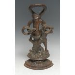 A 19th century cast iron door stop, allegorical as a woodsman striking a serpent and tree, 34.5cm