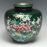 A Japanese cloisonne ovoid vase, decorated with chrysanthemums and blossoming prunus, on a green