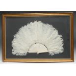 A French Belle Époque lady's ostrich feather evening fan, the ivory sticks and guards carved in