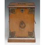 An Edwardian oak novelty biscuit box or tea caddy, as a fall-front 'perdonium', applied to the