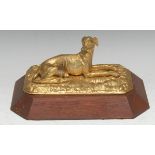 A 19th century gilt metal desk weight, of a reclining greyhound, wooden base, 31cm wide, c.1860