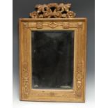 A 19th century giltwood and gesso looking glass, bevelled rectangular mirror plate crested by