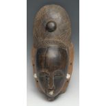 Tribal Art - a Baule mask, lofty coiffure, stylised features picked out in white pigment, 38.5cm