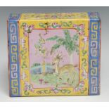 A Chinese pillow, brightly painted in polychrome enamels with deer, butterflies and flowers, on a