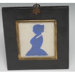 A 19th century cut paper silhouette, of a young lady, three-quarter length in profile facing to