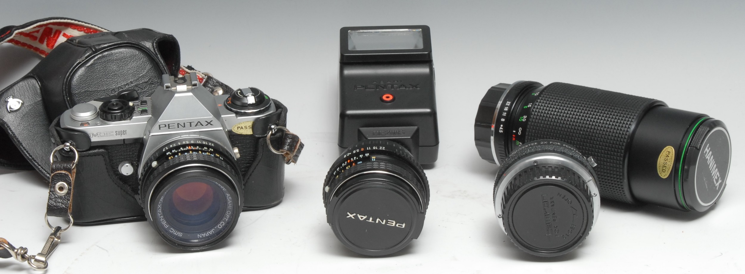 A Pentax ME Super 35mm SLR camera, Pentax-M f1.7 50mm lens, leather case; A Pentax-M f2.8 28mm lens;