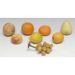 A collection of alabaster table decorations, naturalistically carved and painted as ripe fruit,