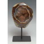 Natural History - Geology - a geode, cut and partially polished to display matrix, mounted for