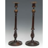 A pair of 19th century mahogany table candlesticks, cast brass campana sconces, fluted pillars,