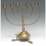 Judaica - a brass Jewish menorah, dolphin feet, 34cm high