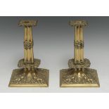 A pair of Charles II style brass candlesticks, fluted square cluster-columns, broad socles cast with