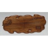 A Chinese hardwood scholar's tray, carved in relief with a cray, a crayfish and seal, 21.5cm wide