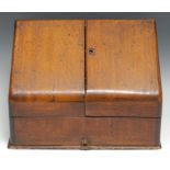 A late Victorian oak slope-front desk-top stationery box, hinged twin-covers enclosing terraced