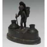 A French Empire dark patinated bronze desk stand, cast with a young grape picker, his hod for