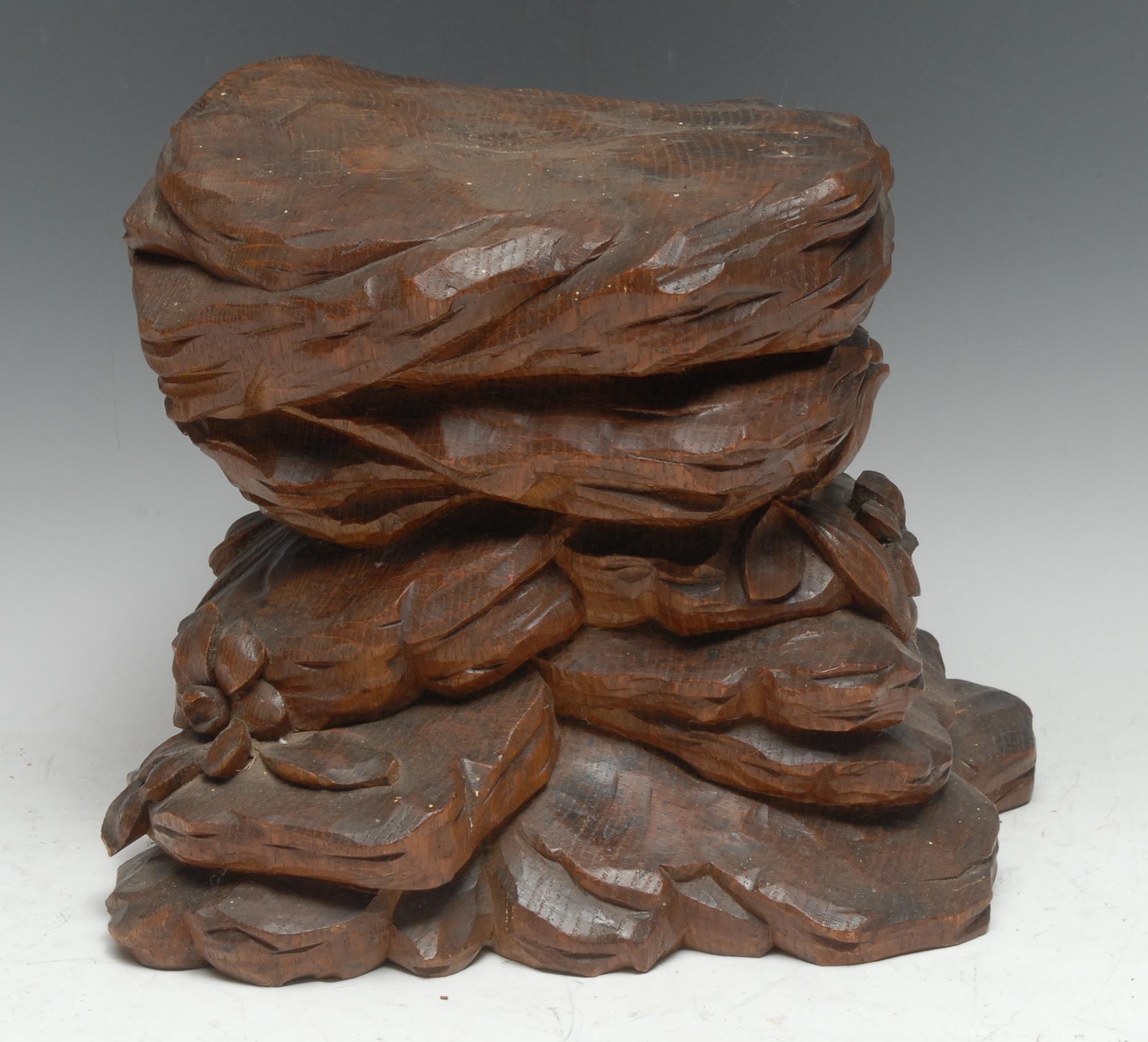 A Black Forest carving, of a rocky outcrop with flowers and leaves, 22cm high, 24cm wide