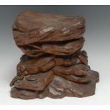 A Black Forest carving, of a rocky outcrop with flowers and leaves, 22cm high, 24cm wide