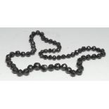A Whitby jet necklace, composed of graduated faceted beads, 45cm drop