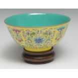 A Chinese circular bowl, brightly painted in polychrome enamels with lotus scrolls and precious