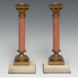 A pair of 19th century gilt bronze and pink marble columnar candlesticks, square sconces with