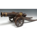 A brass mounted walnut country house model, of an 18th century field canon, 64cm fluted barrel,