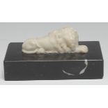 A marble desk weight, carved and applied with a recumbent lion, rectangular base, 15cm wide