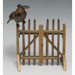 A 19th century bronze novelty letter rack, as a bird perched on a gate, an envelope held in its