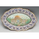 A Middle Eastern enamel shaped oval dish, painted in the Persian Islamic taste with a mosque, within