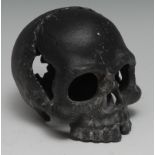 A cast iron 'memento mori', as a skull, 12.5cm long