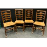 A set of four early 19th century ladder back chairs, rush seats (4)