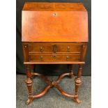 A Carolean style burr walnut bureau, sloping front enclosing fitted interior, above two short and
