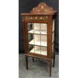 An Art Nouveau mahogany display cabinet, shaped gallery, lead glazed door enclosing lined shelves,
