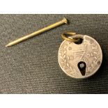 A miniature coin padlock, made from Victorian 1875 silver 3 penny bits