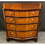 A reproduction bow-front chest of drawers, four graduated cockbeaded drawers, shaped apron,