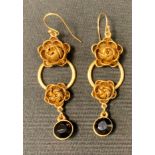 A pair of Pilgrim lady's drop earrings, cast with flowers.