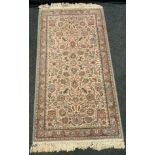 A Kirman-Shah woollen rug, in light tones of blue and pink, 83cm x 160cm