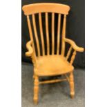A 20th century pine arm chair, outswept arms, saddle seat, double H-stretcher, 112cm high.