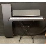 A Roland RD-150 digital piano with stand and flight case, etc