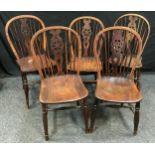A set of five George III elm and oak wheel back dining chairs, saddle seats, H-stretchers.(5)