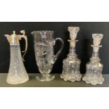 A near pair of Victorian glass stoppered decanters; a large cut glass jug; silver plated clear