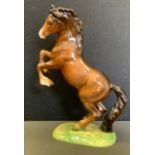 A Beswick model of a rearing horse.