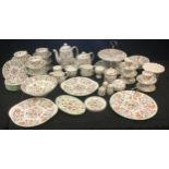 An extensive Minton Haddon Hall pattern table service inc bowl, plates, cups, saucers, three tier