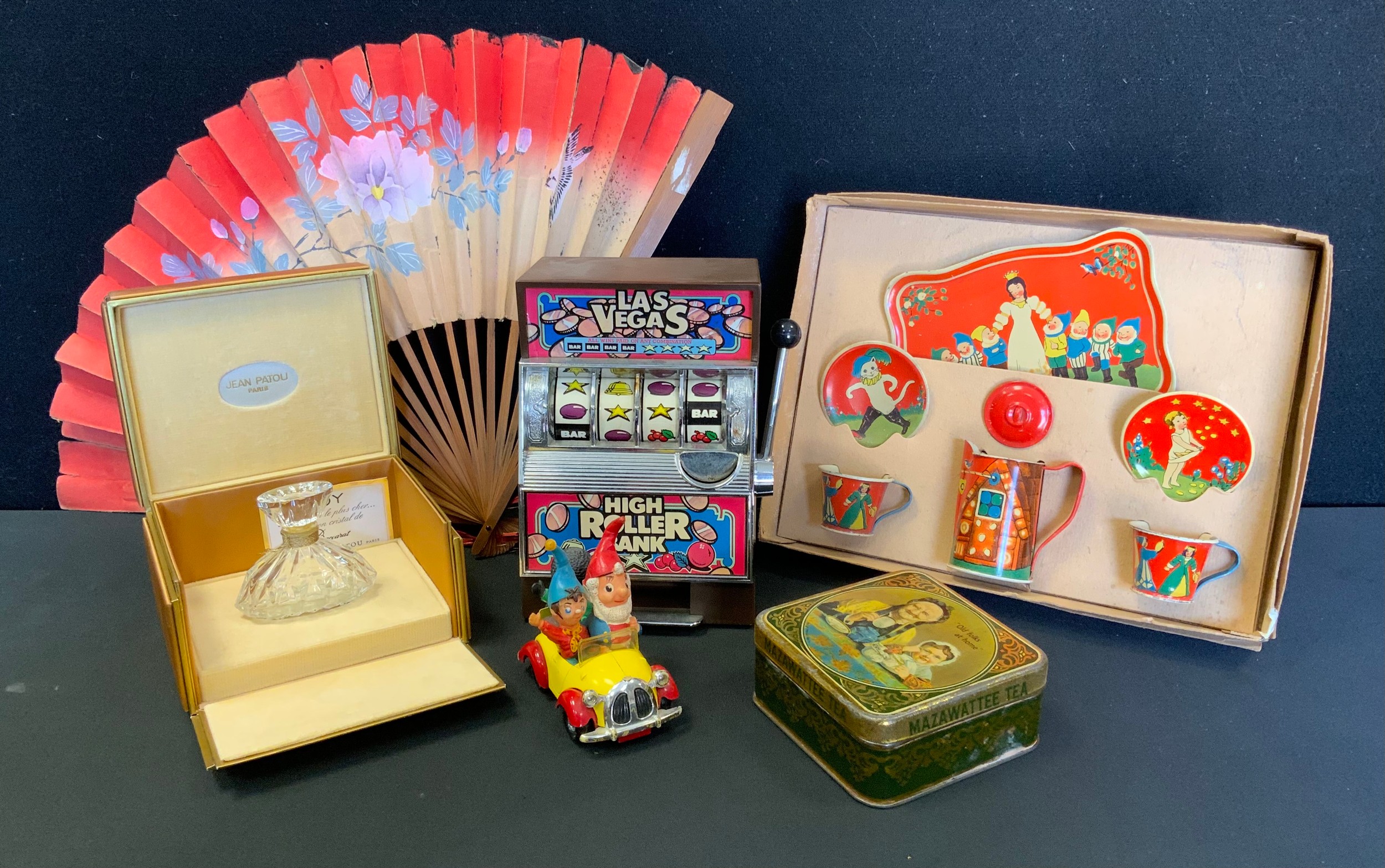 A Corgi Toys Noddy Car; High Roller money bank; Mazawattee Tea tin; Tin plate duet set, boxed; a