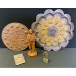 A Persian embossed shaped circular charger, 41cm diameter; another smaller; carved wooden figure;
