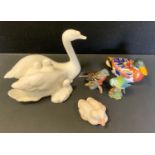 A Royal Crown Derby Duck paperweight, silver stopper; Royal Doulton Images of Nature figure, Swan;
