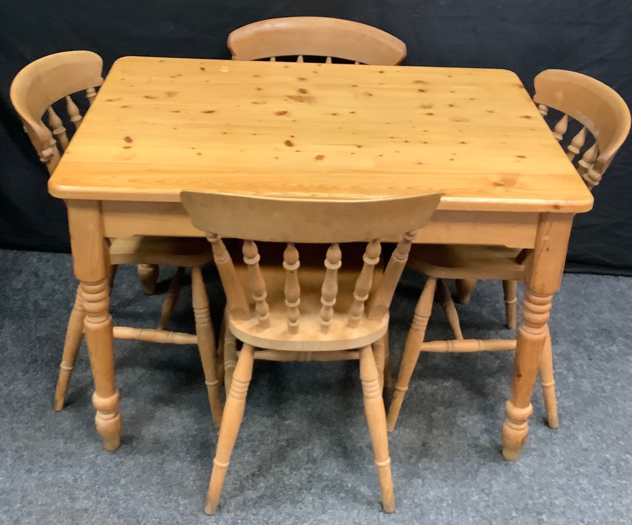 A set of four 20th century pine dining chairs, H-stretchers; a 20th century pine dining table,