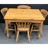 A set of four 20th century pine dining chairs, H-stretchers; a 20th century pine dining table,