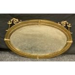 A Neoclassical brass oval wall mirror, beveled plate, 50cm x 78cm.