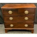 A George III mahogany chest of small proportions, with two short over three long drawers, brass