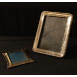 A George V silver rounded rectangular easel photograph frame, egg and dart borders, ebonised to